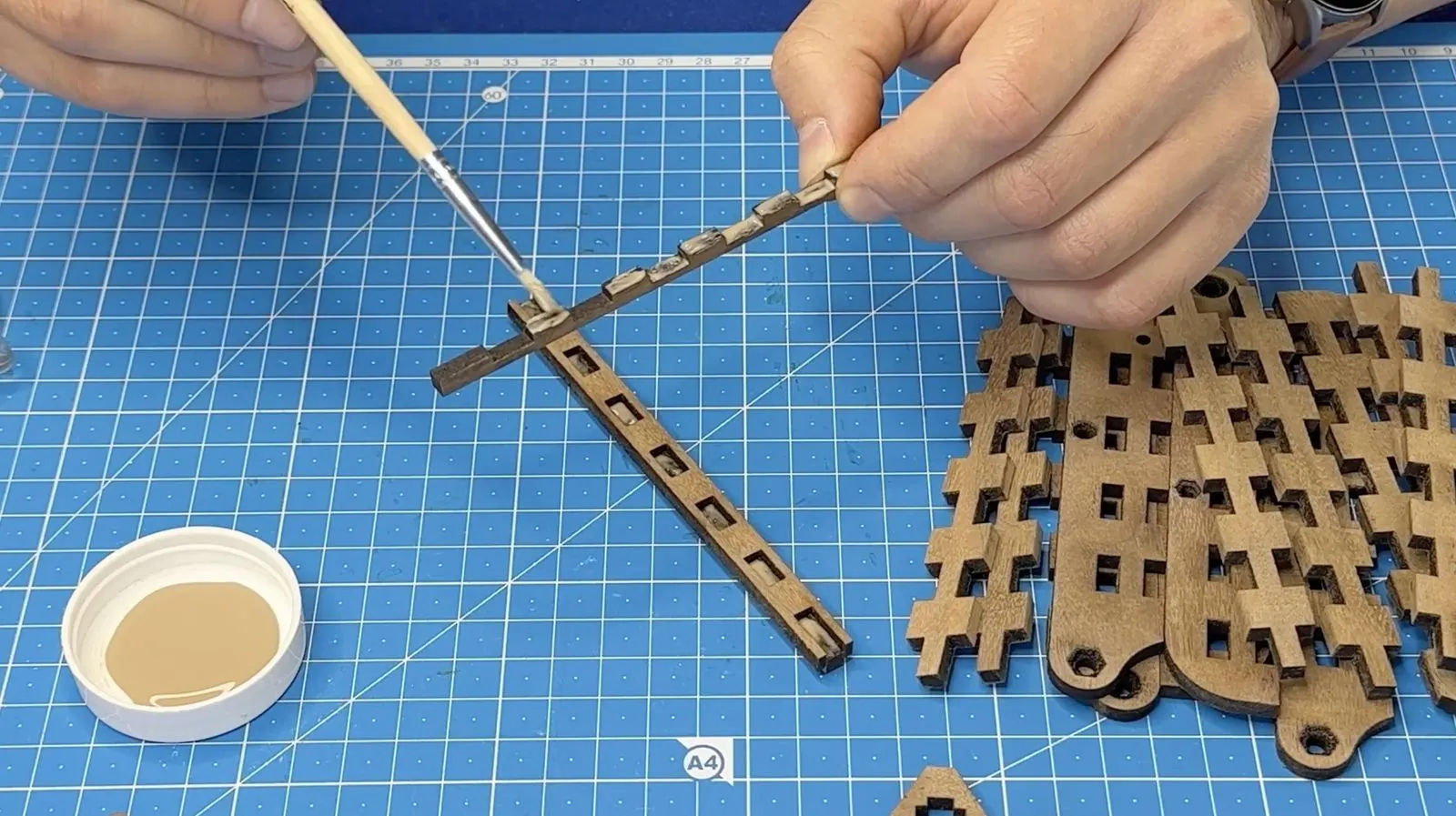 Foldable Wooden Tripod: applying finish to a leg component